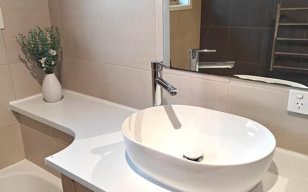 Above counter basin with a tall mixer tap