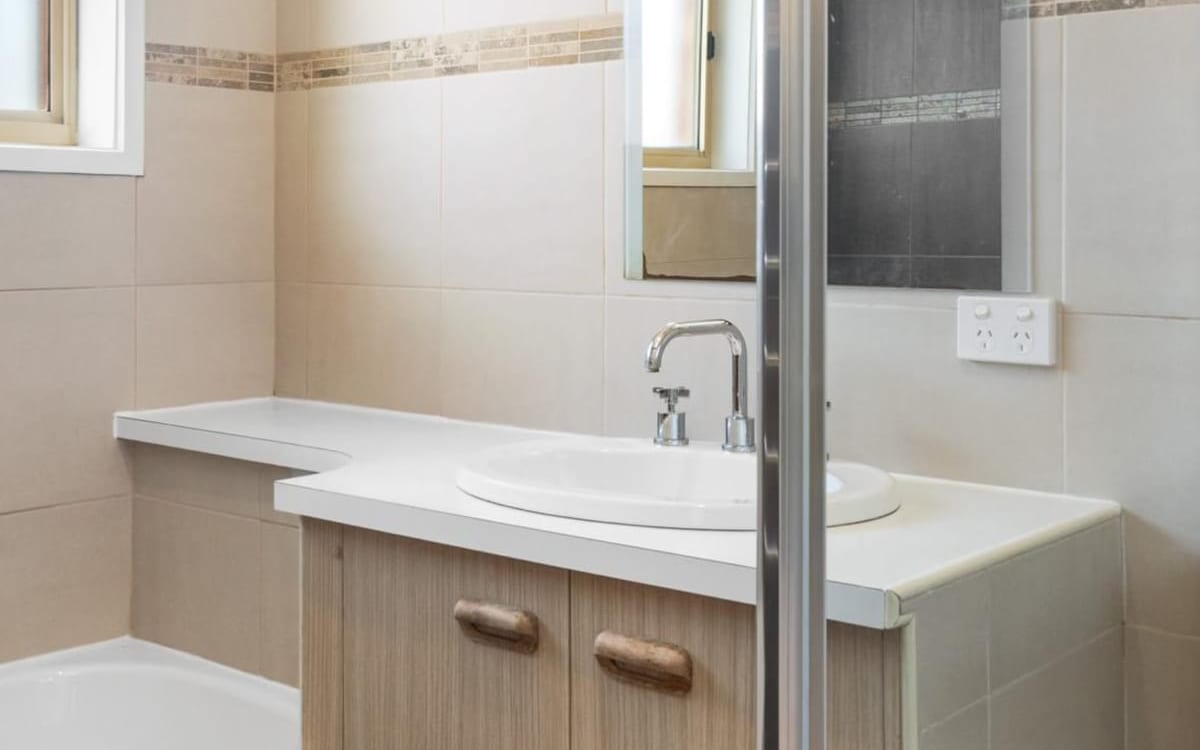Renovated bathroom vanity, bath and shower screen