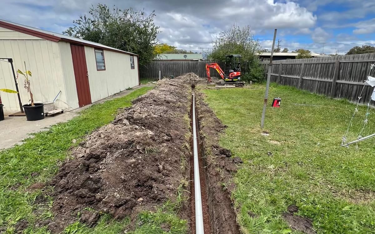 Stormwater pipe laid in a backyard trench