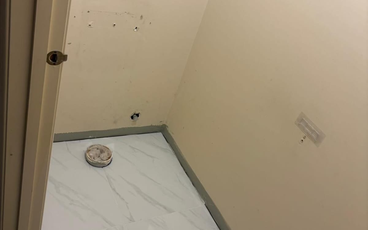 Toilet room tiled and ready for a new toilet