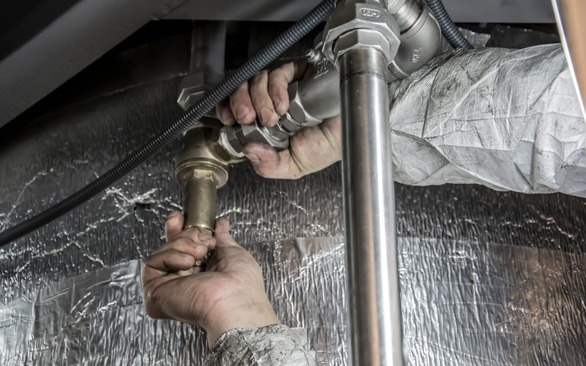 Plumber repairing a pipe fitting