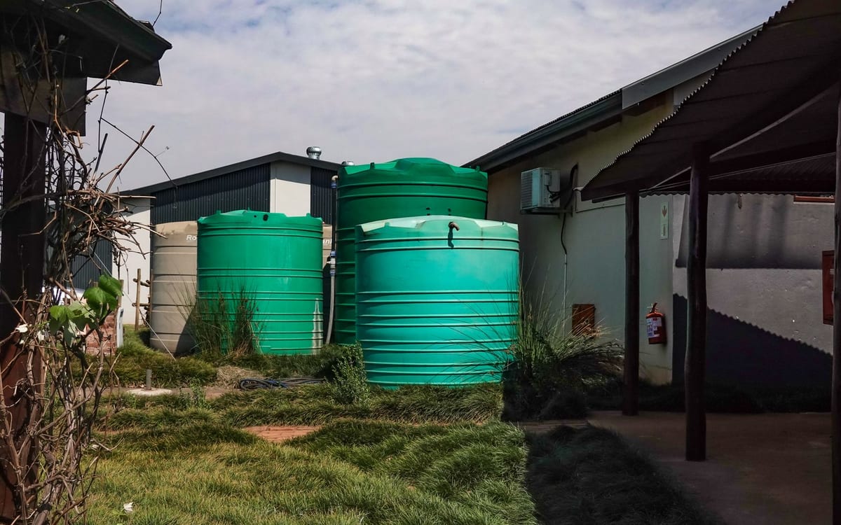 Rainwater tanks beside a house
